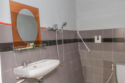a bathroom with a sink and a shower at RedDoorz Plus @ Otista Garut in Garut