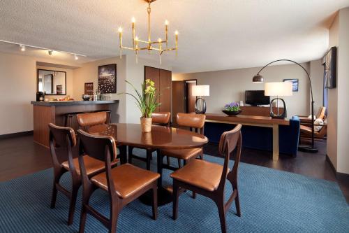 a dining room and living room with a table and chairs at Hyatt Regency Minneapolis in Minneapolis