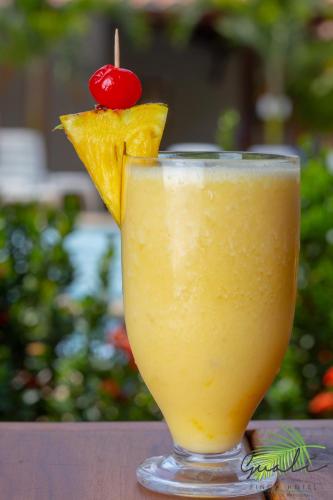 a glass of orange juice with a cherry on top at Finca Hotel Guali Santafe in Santa Fe de Antioquia