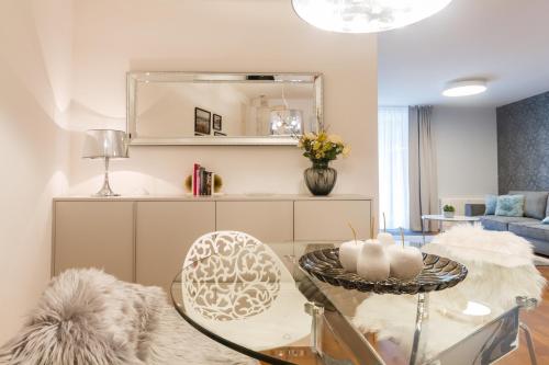 a living room with a glass table and a couch at Apartments Lux by Locap Group in Portorož