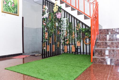 a room with a gate with green grass and flowers at RedDoorz Syariah near Gelora Delta Sidoarjo 2 in Sidoarjo