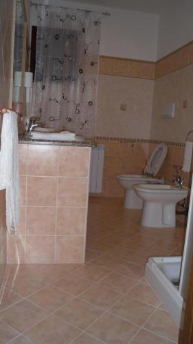 a bathroom with two toilets and a sink at B&B La Collina in Posada