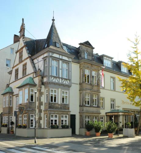 a large building with a flag in front of it at Hotel Detmolder Hof in Detmold