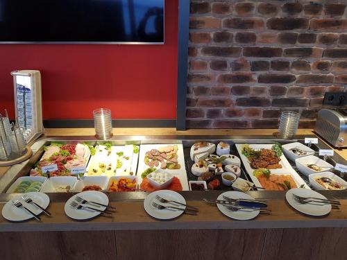 a buffet with many different types of food on a table at Hotel Hafenresidenz Stralsund in Stralsund
