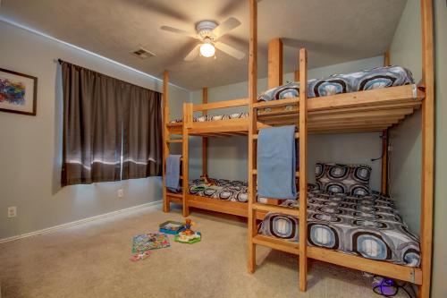 a bedroom with two bunk beds and a ceiling fan at Pecan Point by KABINO Mountain Trail Access Foosball Table Private Yard Firepit WiFi Grill in Hurricane