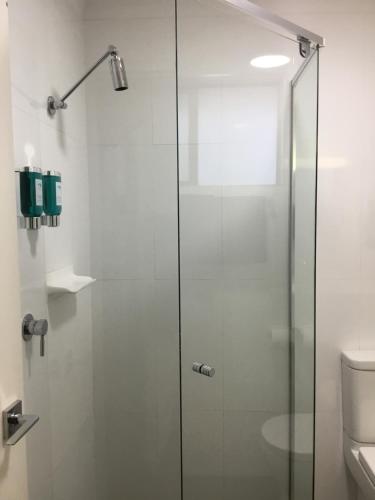 a shower with a glass door in a bathroom at Jervis Bay Motel in Huskisson