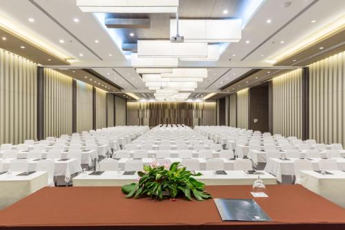 an empty conference room with white chairs and tables at Kantary Hotel Korat in Nakhon Ratchasima