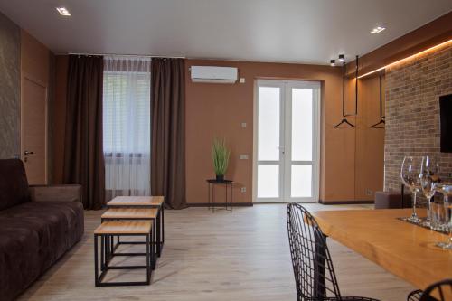 a living room with a couch and a table at Prestige Apartments Kalnyshevskogo in Dnipro