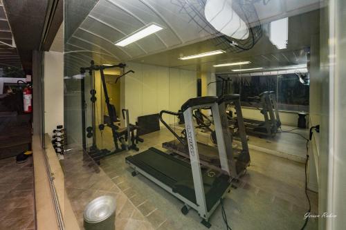 a room with a gym with machines in it at Max Savassi Premier 14 in Belo Horizonte