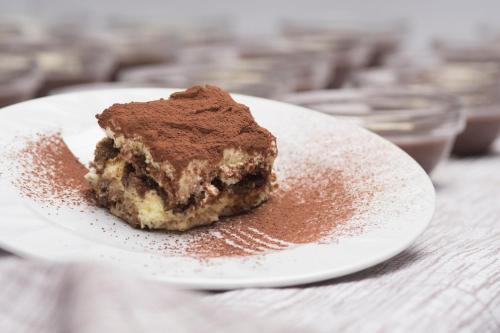 a piece of cake on a plate on a table at Arco Smart Hotel in Arco
