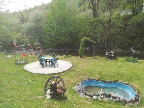a garden with a picnic table and a playground at Villa Bulgarka in Divchovoto
