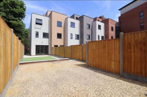 a wooden fence in front of some buildings at Central Unite management Ltd in Manchester