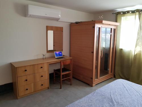 a bedroom with a desk with a laptop on it at Auberge de Provence in Siġġiewi