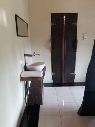 a bathroom with a sink and a shower in a room at Sumatra Cheeky Monkeys in Bukit Lawang
