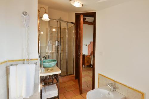 a bathroom with a glass shower and a sink at San Francesco Resort in Agropoli