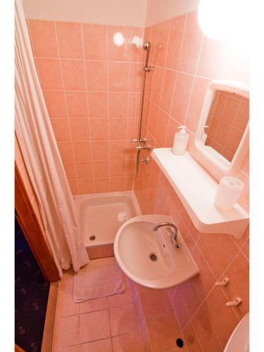 a bathroom with a sink and a shower and a toilet at Villa Mia Casa in Supetar