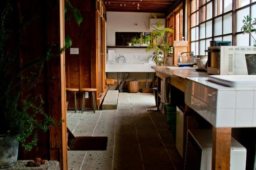 a kitchen with a sink and a counter top at Hostel Saruya in Fujiyoshida
