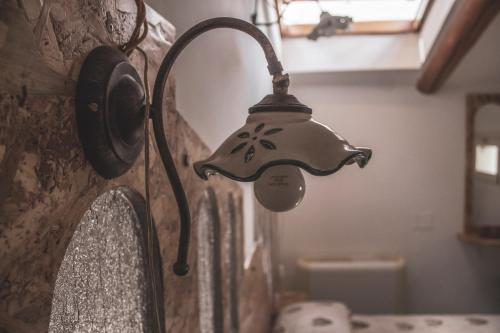 a light hanging on a wall next to a sink at Grande borgo in Cava deʼ Tirreni