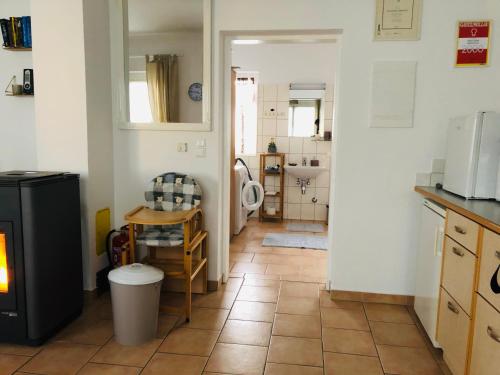 a kitchen with a tile floor and a kitchen with a sink at Ferienhaus Villach in Villach