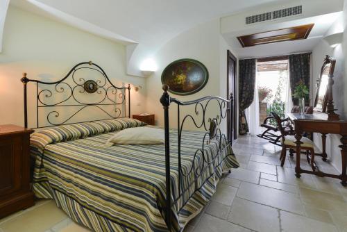a bedroom with a bed and a piano at San Francesco Resort in Agropoli