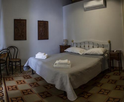 a bedroom with a bed with towels on it at Borgo Civico 10 in Cava deʼ Tirreni
