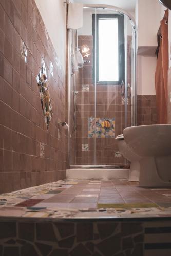 a bathroom with a shower and a toilet at Borgo Civico 10 in Cava deʼ Tirreni