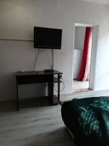 a living room with a flat screen tv on a wall at Rooms and Apartments Milana in Bar