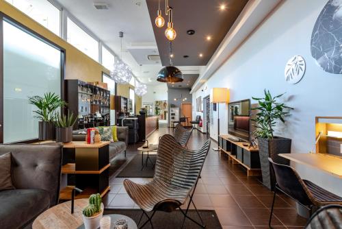 a lobby of a store with chairs and tables at ibis Styles Dortmund West in Dortmund