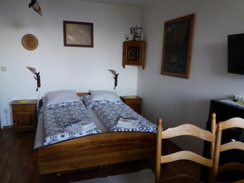 a bedroom with a bed and a tv in a room at Apartma mit Seeblick in Sankt Gilgen