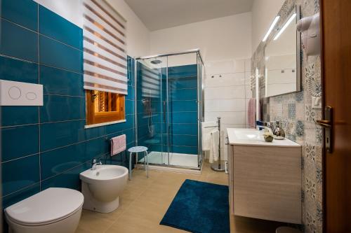 a bathroom with a toilet and a sink and a shower at Casa dei Coralli in Castellammare del Golfo