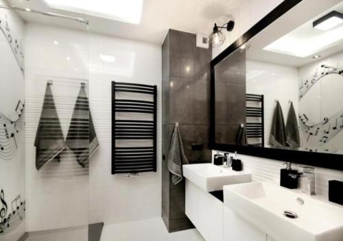 a bathroom with two sinks and a mirror at Bulwary Wislane P&O Serviced Apartments with AC in Warsaw