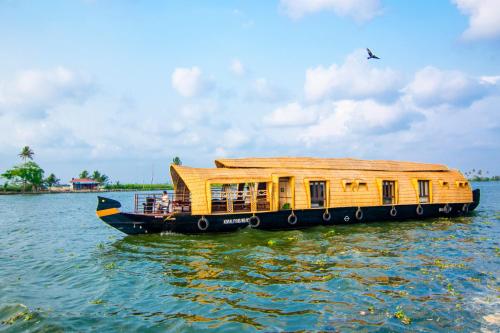 a boat with a house on the water at Marvel Cruise in Alleppey