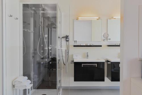 a white bathroom with a shower and a sink at Stay Michelangelo Jesolo Only Adults in Lido di Jesolo