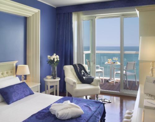 a bedroom with a bed and a view of the ocean at Hotel Tiffany's in Riccione