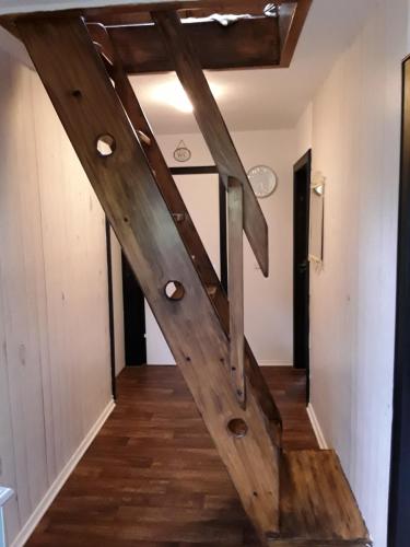 a wooden staircase in a room with wooden floors at Villa Jani b&b in Breitscheid