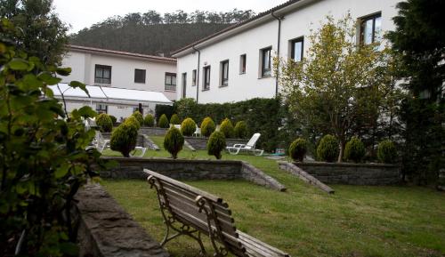 a park bench in the yard of a building at Hotel Mirador de La Franca in La Franca