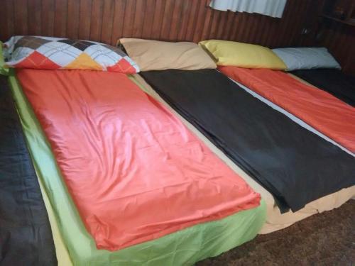 two beds with colorful covers sitting next to each other at Tiger House Guest House in Bcharré