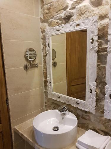 a bathroom with a white sink and a mirror at Domaine de Vareilles in Vareilles