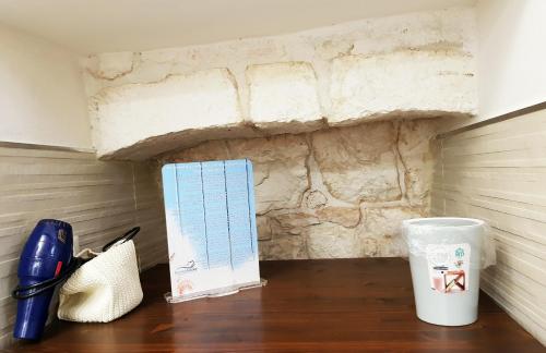 a desk with a notebook and a pen and a cup at BiancoAmore OSTUNI - the sky, the sea, the love - in Ostuni