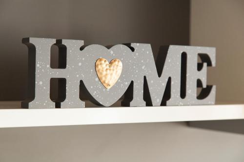 a wooden sign that says mum with a heart on a shelf at Wex 1 Apartments in Cape Town