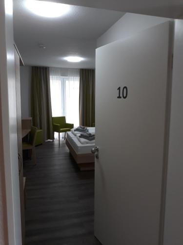 a room with a room with a bed and a door at Hotel Restaurant Zum Wacholderhain in Haselünne
