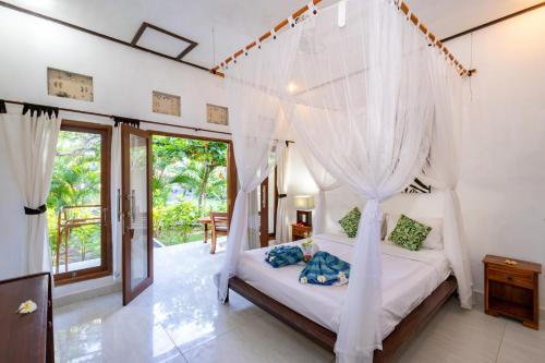 Cama o camas de una habitación en Taos House Lembongan By DeWizZ Management