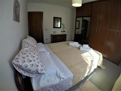a bedroom with a large bed in a room at Sardinia-holiday casa Pesce Palla in La Maddalena