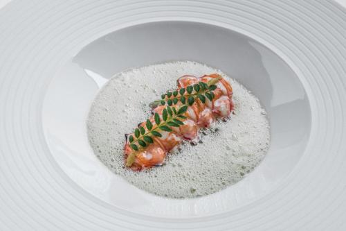 a white plate with a piece of food on it at Hotel Ketschauer Hof in Deidesheim
