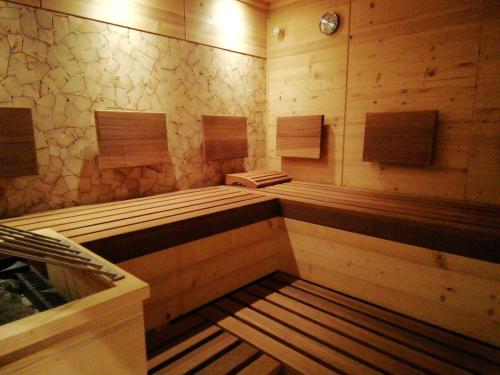 a sauna with wooden paneled walls and a wooden bench in a room at Tirol Appartement Haus Zillertal in Zell am Ziller