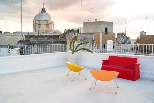 a room with two chairs and a couch on a roof at B & B Sotto la Volta in Massafra