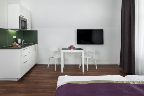 a room with a kitchen and a table with chairs at Elizabeth Suites in Prague