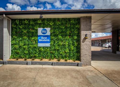 a green wall with a best western sign in a garage at Best Western Endeavour Motel in Maitland