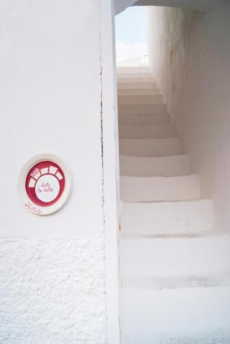 a stairway with a clock on a wall at B & B Sotto la Volta in Massafra