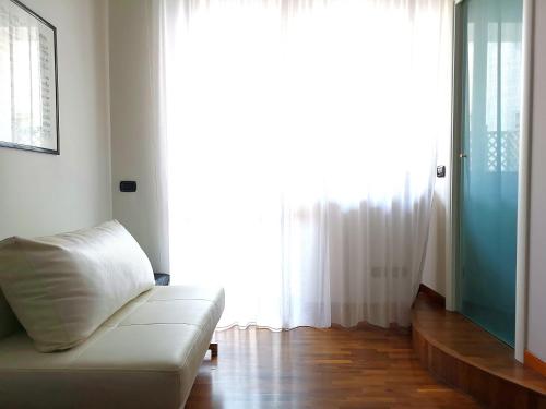 a living room with a couch and a large window at Attico Barocco in Lecce